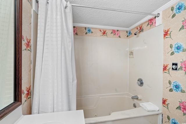 bathroom with a textured ceiling, wallpapered walls, shower / bath combo with shower curtain, and crown molding