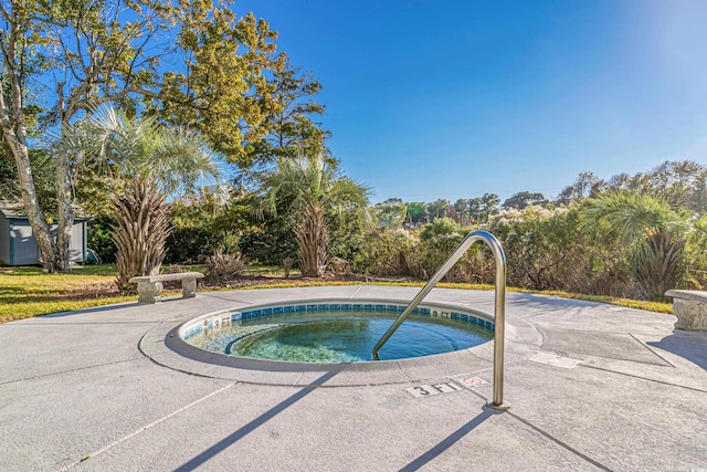 view of swimming pool featuring an in ground hot tub