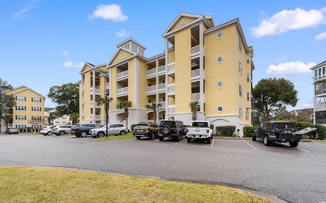 view of building exterior with uncovered parking