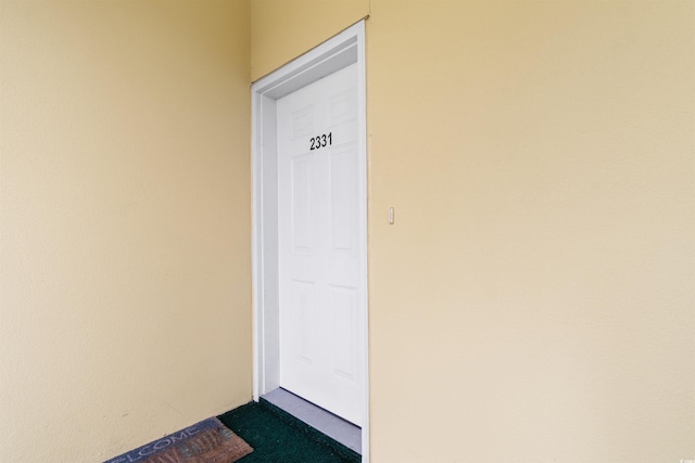 property entrance with stucco siding