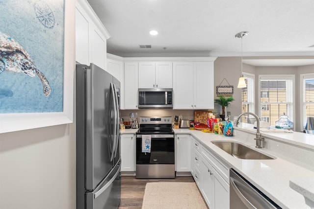 kitchen with visible vents, appliances with stainless steel finishes, white cabinetry, and a sink