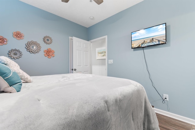 bedroom with wood finished floors, baseboards, and ceiling fan