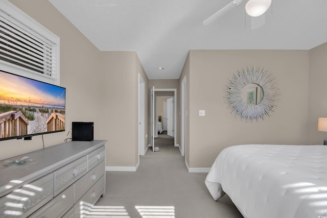 bedroom featuring baseboards, ceiling fan, and light colored carpet