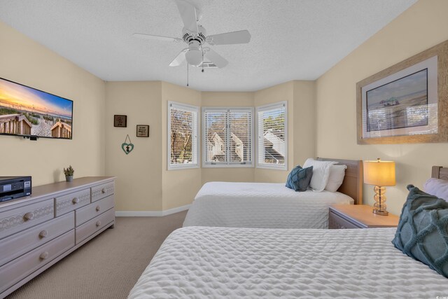 carpeted bedroom with baseboards, a ceiling fan, and a textured ceiling
