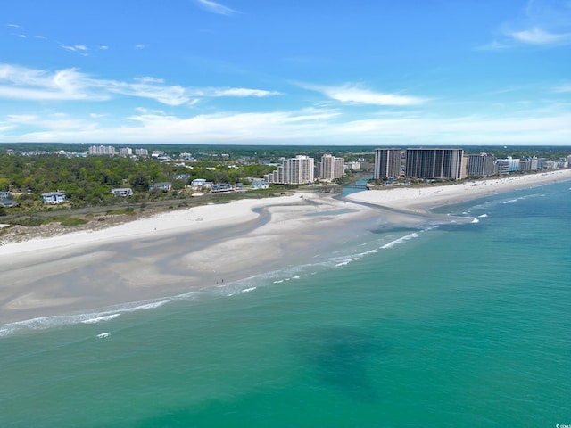 bird's eye view featuring a water view, a view of the beach, and a view of city