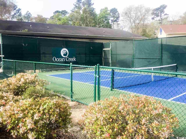 view of tennis court featuring fence