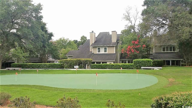 view of property's community with a yard