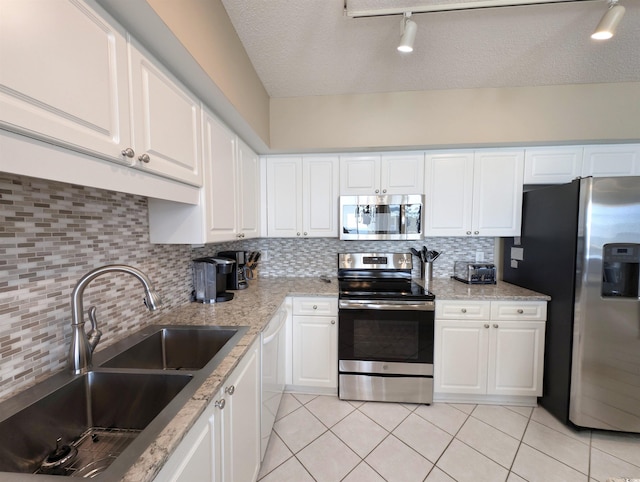 kitchen featuring a sink, appliances with stainless steel finishes, and white cabinets