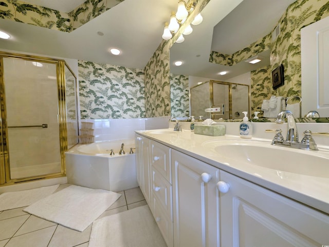 bathroom featuring a sink, a shower stall, tile patterned flooring, and wallpapered walls