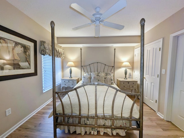 bedroom featuring wood finished floors and baseboards