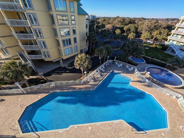 pool with fence and a patio area