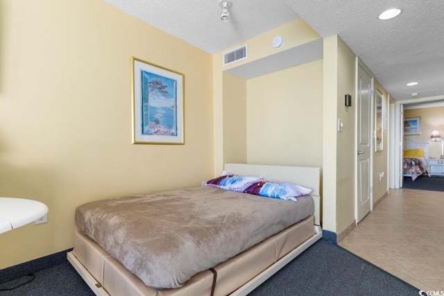 300 N Ocean Blvd Unit 731, North Myrtle Beach, SC 29582 - tiled bedroom featuring a textured ceiling, carpet floors, recessed lighting, and baseboards
