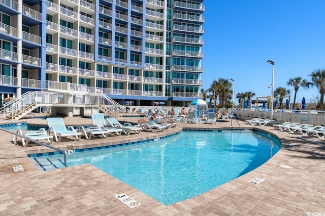 300 N Ocean Blvd Unit 731, North Myrtle Beach, SC 29582 - community pool featuring a patio area, fence, and stairway