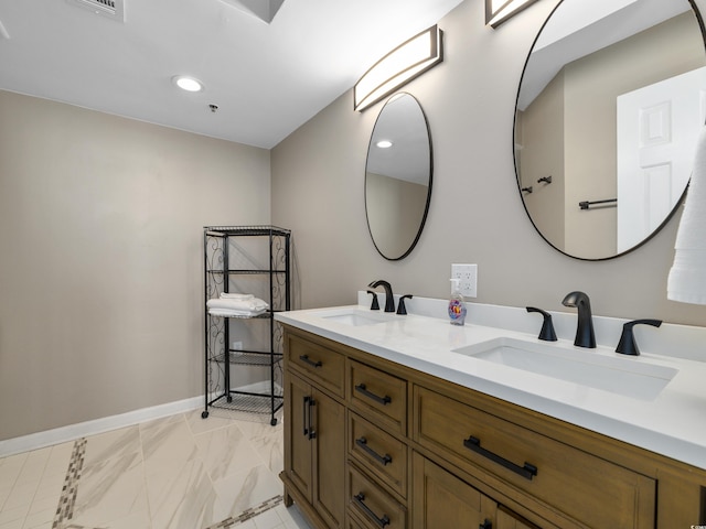 full bath with double vanity, recessed lighting, baseboards, and a sink