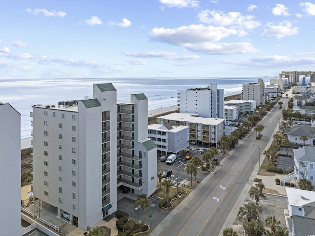 birds eye view of property featuring a city view and a water view