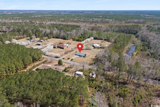 birds eye view of property with a wooded view