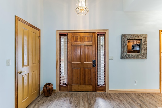 entrance foyer with baseboards and wood finished floors