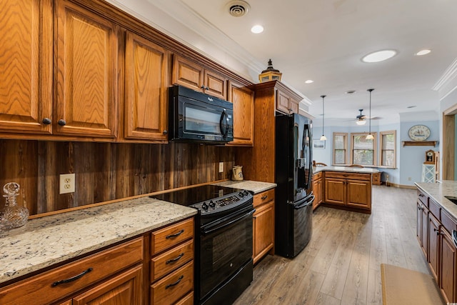 kitchen with visible vents, crown molding, light stone counters, brown cabinets, and black appliances