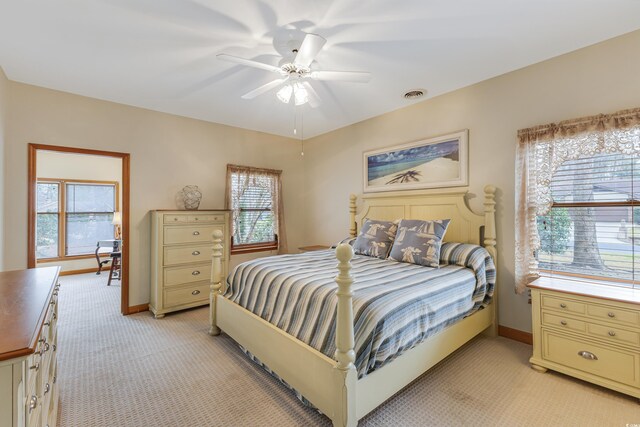 bedroom with visible vents, light carpet, baseboards, and ceiling fan