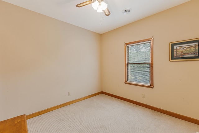 unfurnished room featuring visible vents, light carpet, and baseboards