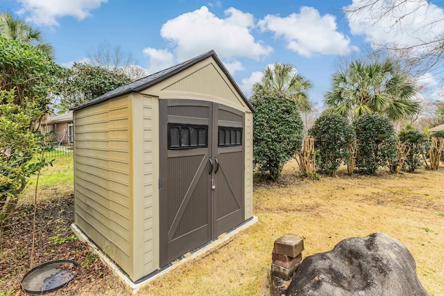 view of shed with fence