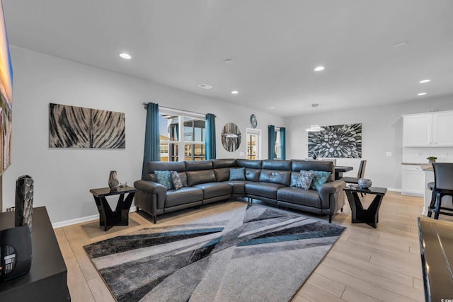 living area with light wood-style flooring, recessed lighting, and baseboards