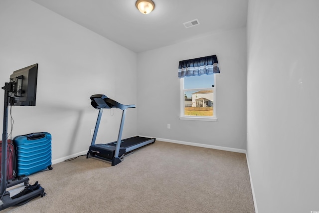 exercise area featuring visible vents, baseboards, and carpet