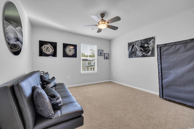 sitting room featuring visible vents, baseboards, a ceiling fan, and carpet floors