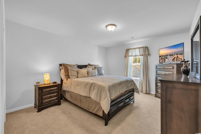 bedroom with visible vents, baseboards, and light colored carpet