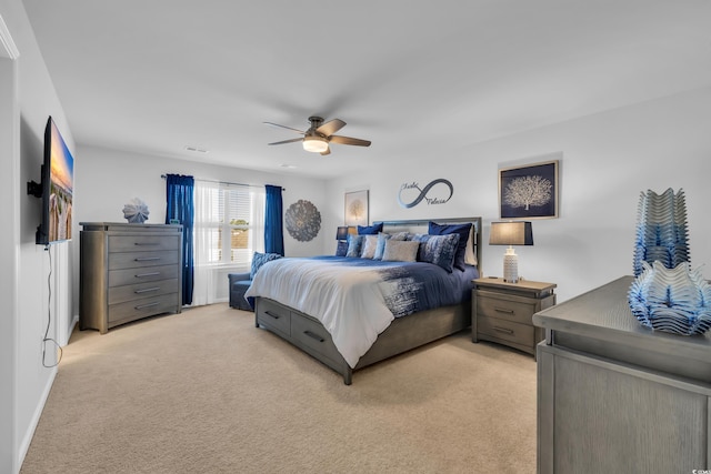 bedroom with a ceiling fan, light colored carpet, and visible vents