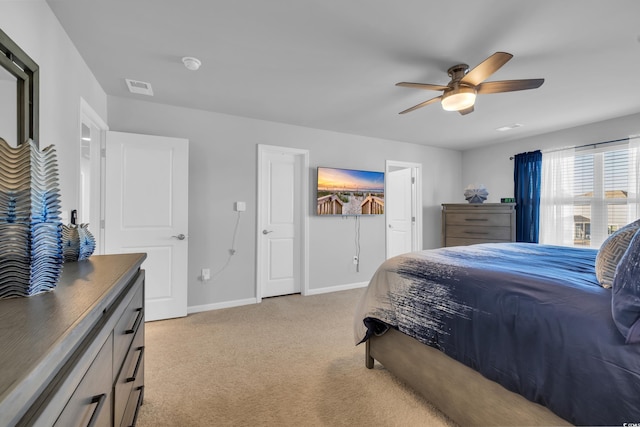 bedroom featuring ceiling fan, baseboards, visible vents, and light carpet