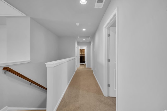 hall featuring an upstairs landing, visible vents, recessed lighting, and light carpet