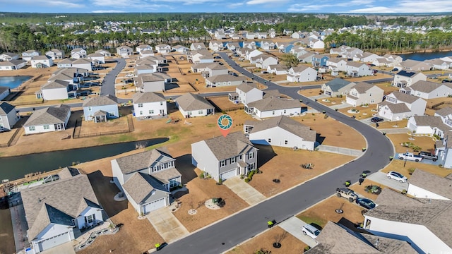 drone / aerial view with a residential view and a water view