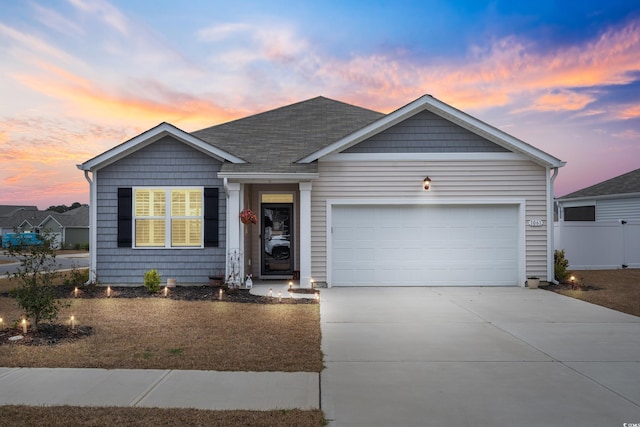 ranch-style home featuring driveway, an attached garage, roof with shingles, and fence