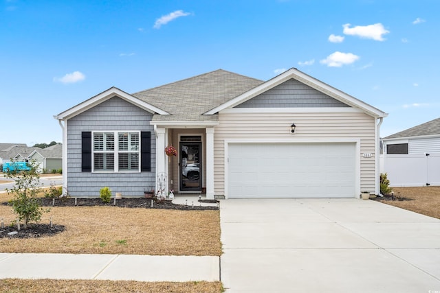 ranch-style house featuring a garage, roof with shingles, driveway, and fence