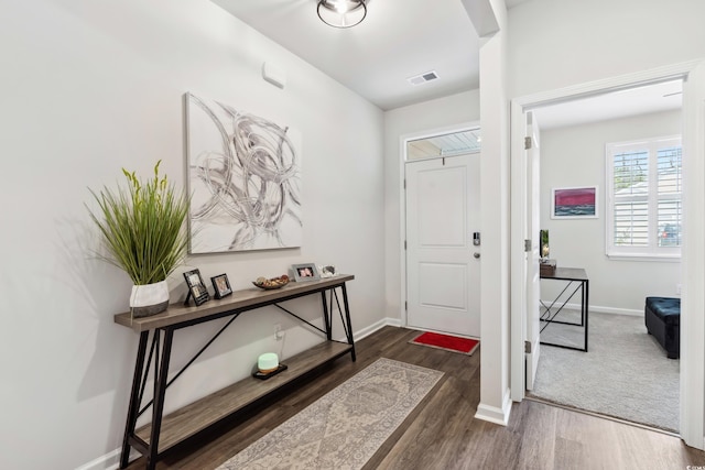 entrance foyer featuring visible vents, baseboards, and wood finished floors