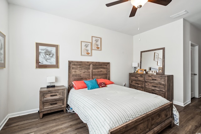 bedroom with visible vents, baseboards, wood finished floors, and a ceiling fan