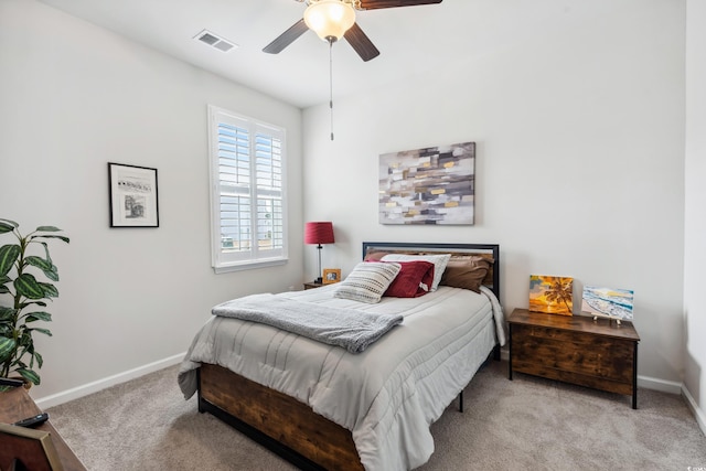 bedroom with ceiling fan, carpet, visible vents, and baseboards