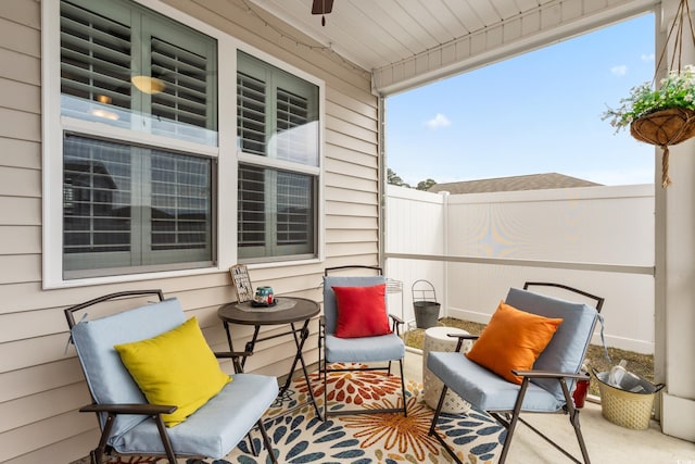 view of patio / terrace with a ceiling fan and fence