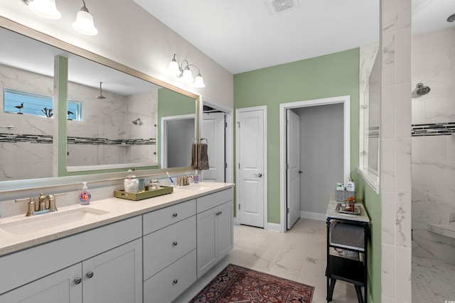 full bathroom featuring a walk in shower, visible vents, marble finish floor, and a sink