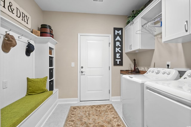 washroom with visible vents, cabinet space, independent washer and dryer, and baseboards