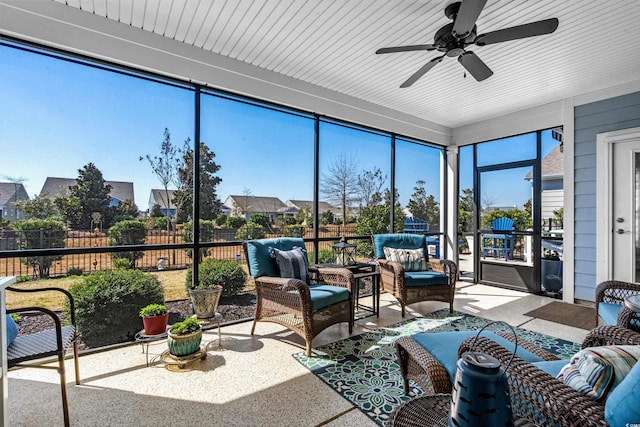 sunroom featuring a healthy amount of sunlight and ceiling fan