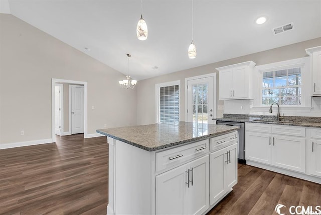 kitchen with visible vents, vaulted ceiling, stainless steel dishwasher, dark wood-style floors, and a sink