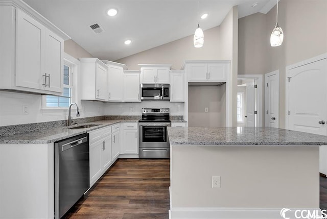 kitchen with visible vents, white cabinets, stainless steel appliances, and a sink