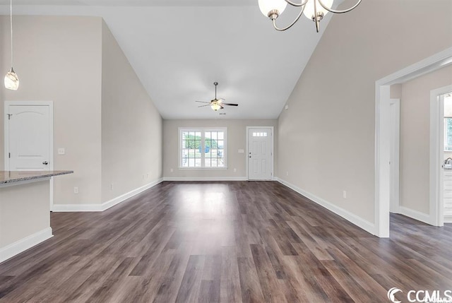 unfurnished living room featuring baseboards, high vaulted ceiling, and dark wood-style floors