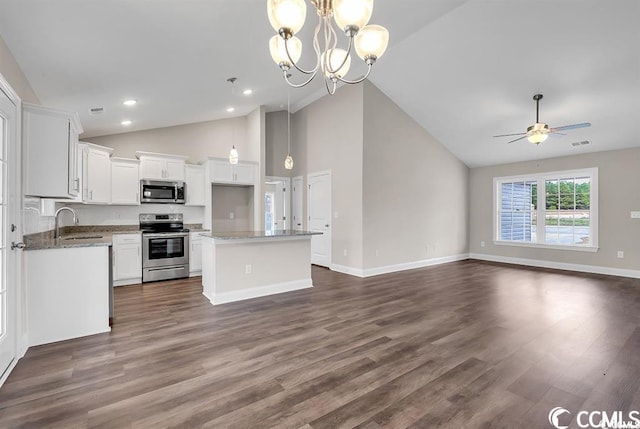 kitchen featuring visible vents, a sink, open floor plan, white cabinetry, and stainless steel appliances