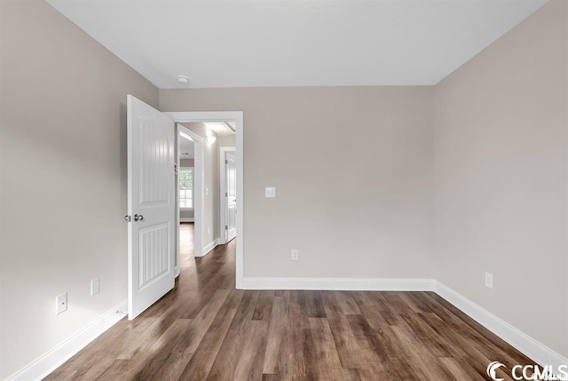 empty room with wood finished floors and baseboards