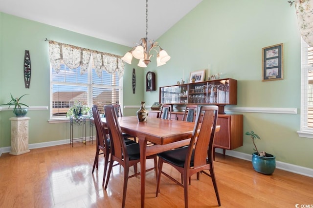 dining room with wood finished floors, baseboards, and a chandelier