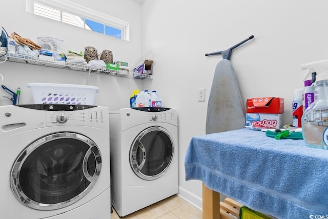 laundry area featuring light tile patterned floors, laundry area, and separate washer and dryer