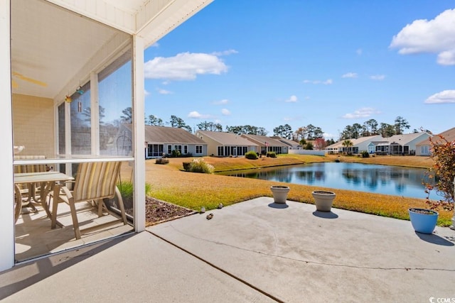 view of patio featuring a residential view and a water view